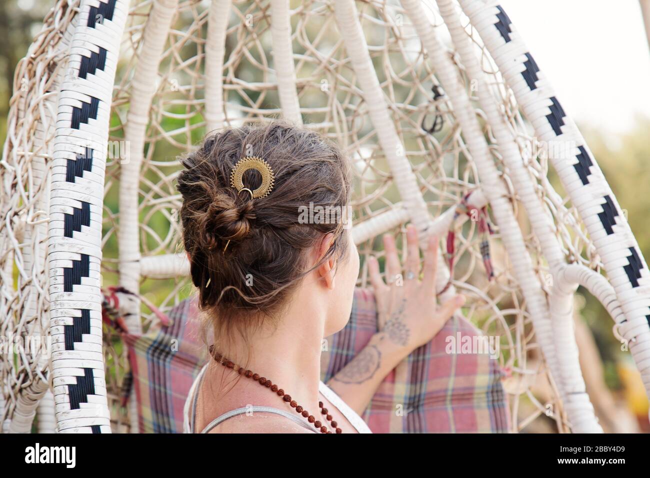 Elegant woman in a swing wearing metal hair pin in her hair bun Stock Photo