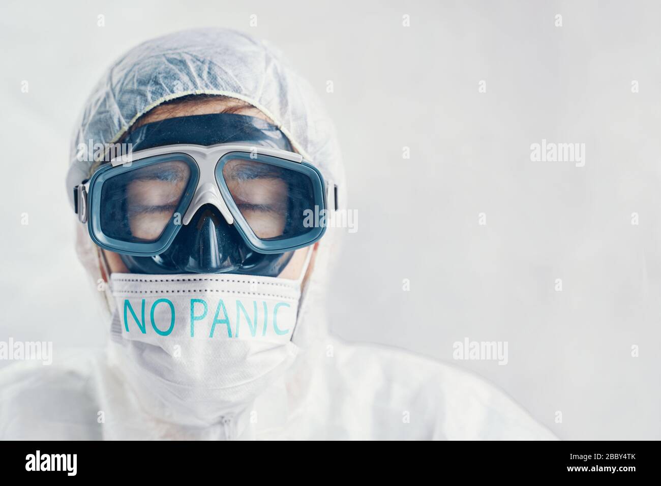 Human bio suit and protective mask with the inscription No panic Stock Photo