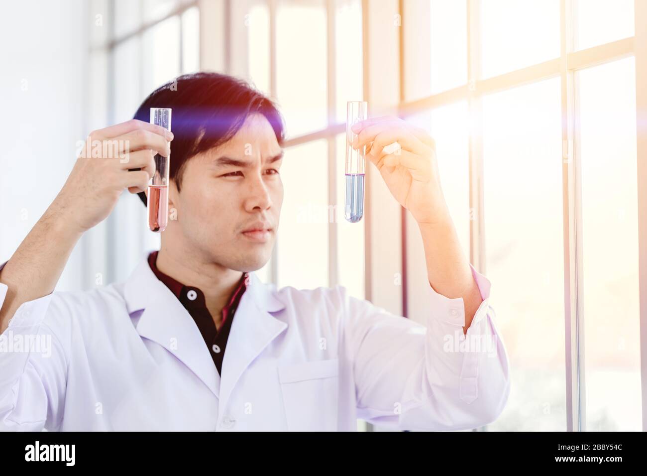Scientist successful discover new drug formula by choice select good chemical liquid in medical science lab Stock Photo