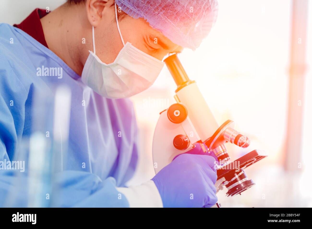 Scientist Doctor dressing PPE protective suit working in medical lab for finding anti virus vaccine Stock Photo