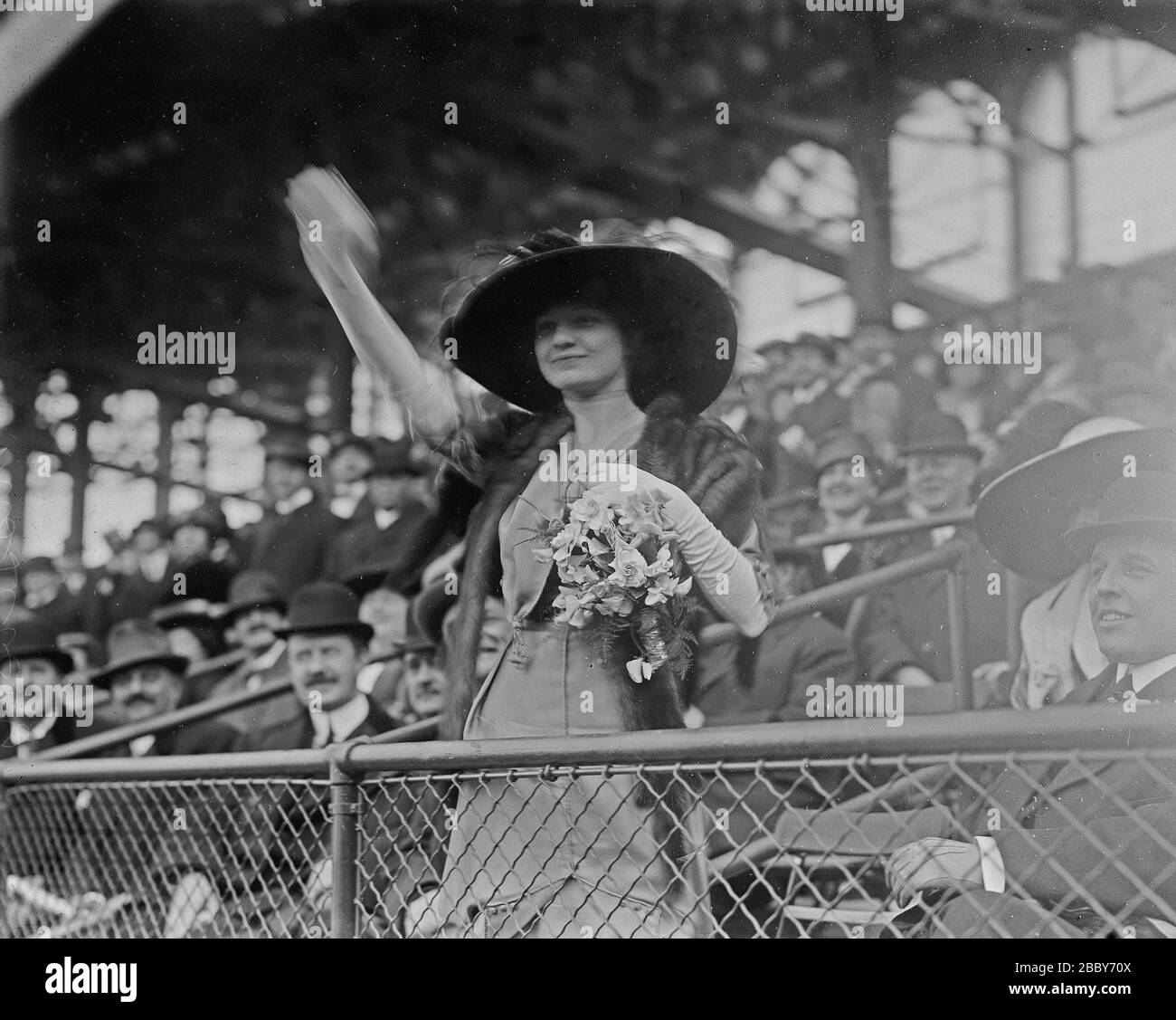 Miss Genevieve Ebbets, youngest daughter of Charley Ebbets, throws first ball at opening of Ebbets Field ca. 1913 Stock Photo
