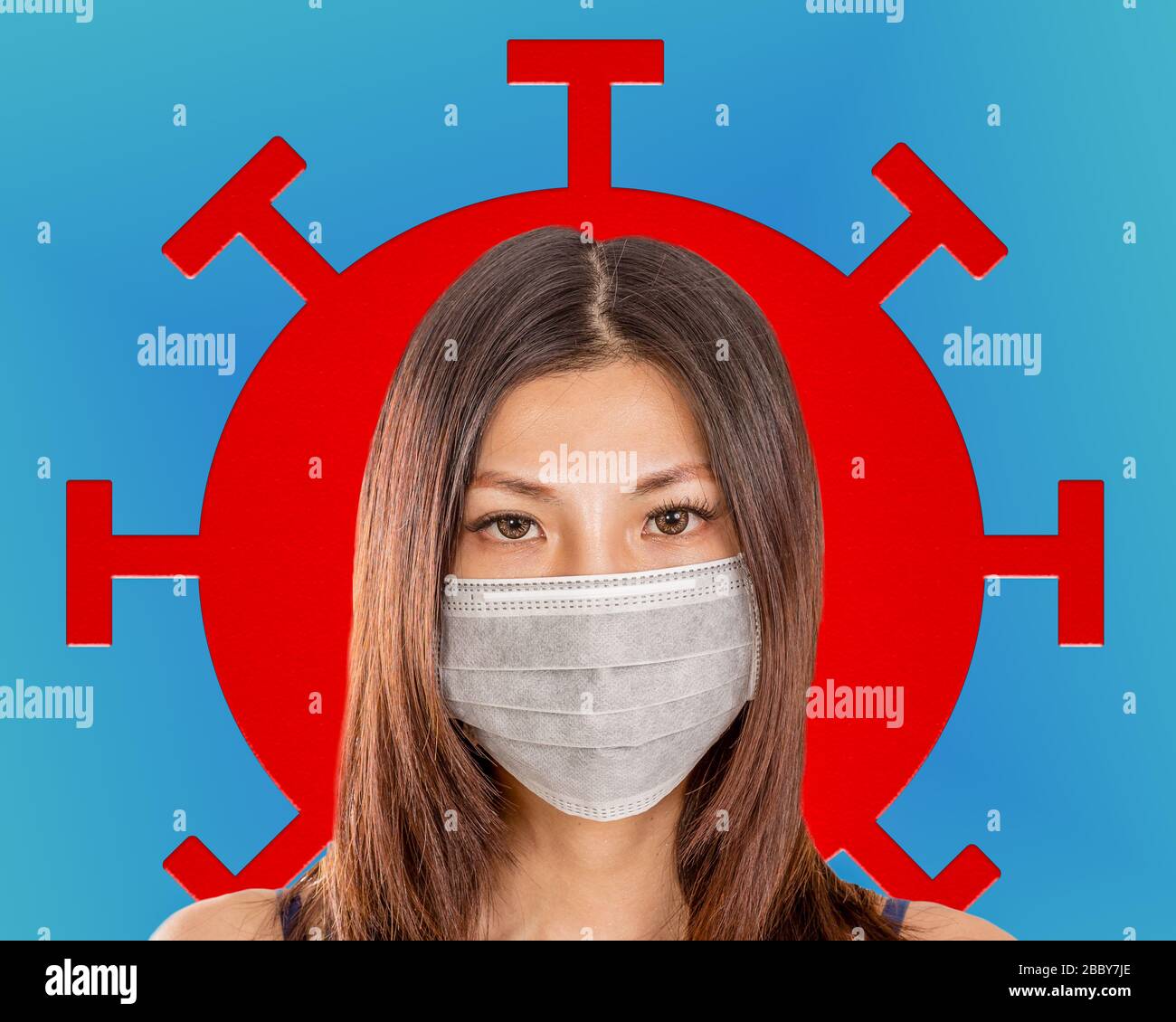 Asian American woman wearing surgical mask with coronavirus cell in background Stock Photo