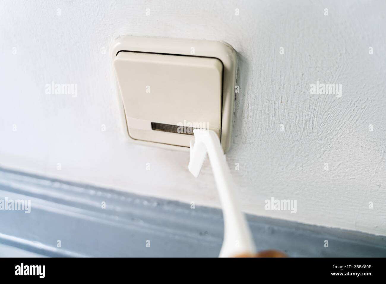 Man Using Contactless Tool To Press Button To Protect From Coronavirus Infection Stock Photo