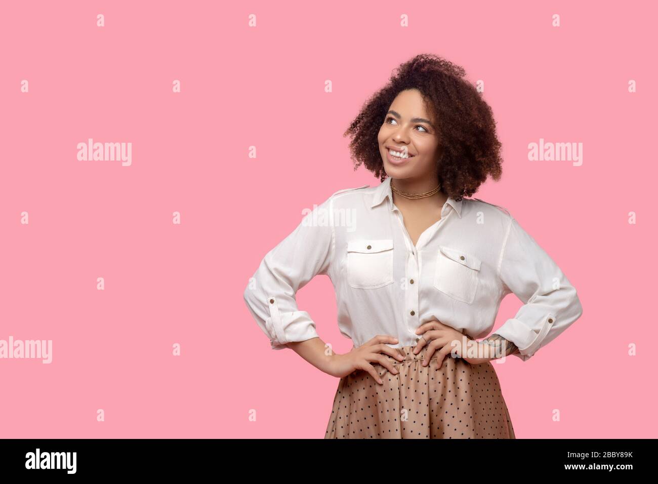 Woman standing curly brown hi-res stock photography and images - Alamy