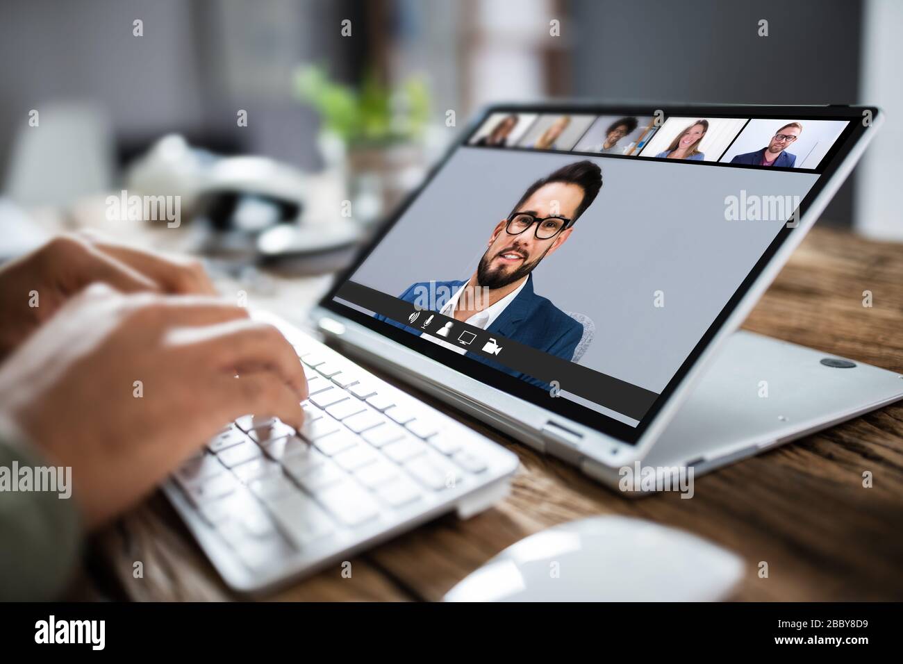 Man Having Online Group Videoconference On Laptop Stock Photo