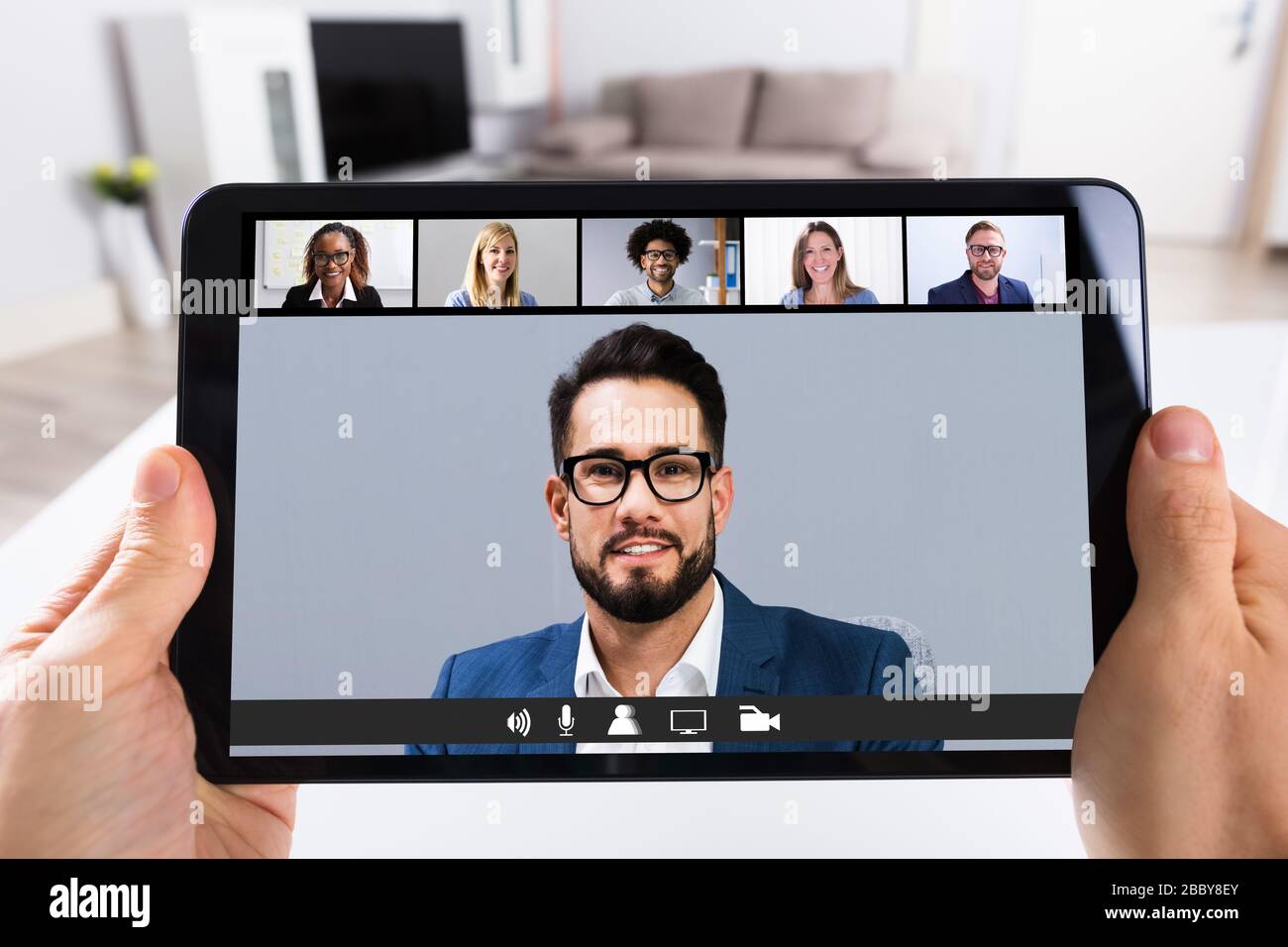 Man Working From Home Online Group Videoconference On Tablet Stock Photo