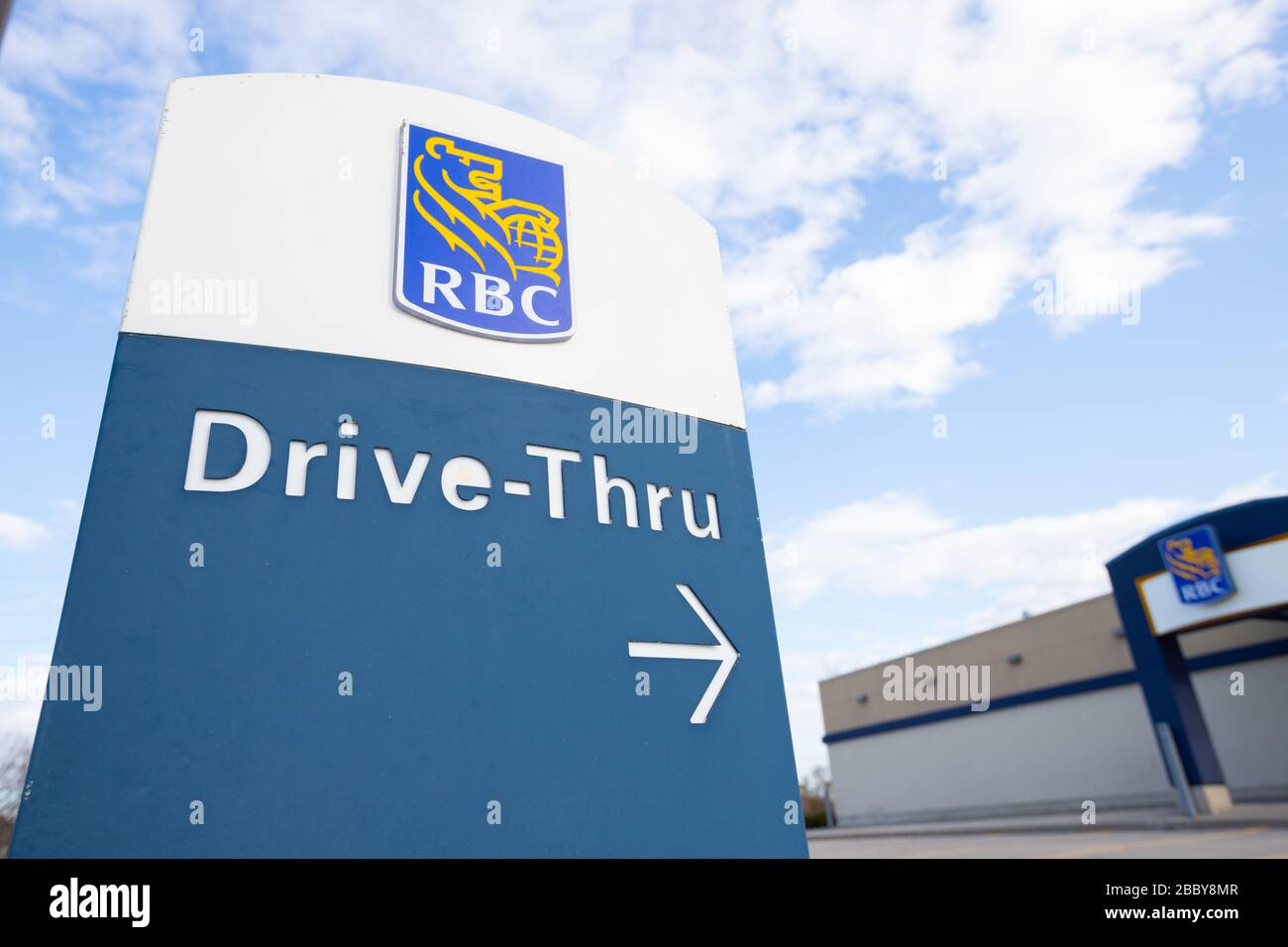 A sign showing Royal Bank of Canada (RBC) drive thru to the ATM. Self serve banking machines. Stock Photo