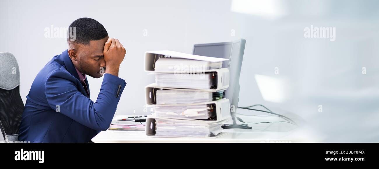 Workaholic Manager Employee With Headache And Stress Stock Photo