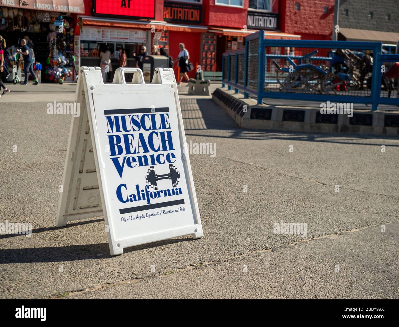 Muscle Beach Venice Beach signboard next to outdoor destination gym