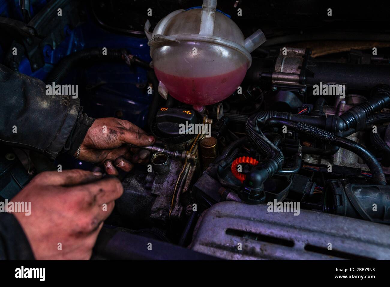 the master repairs the engine in the car service during a malfunction