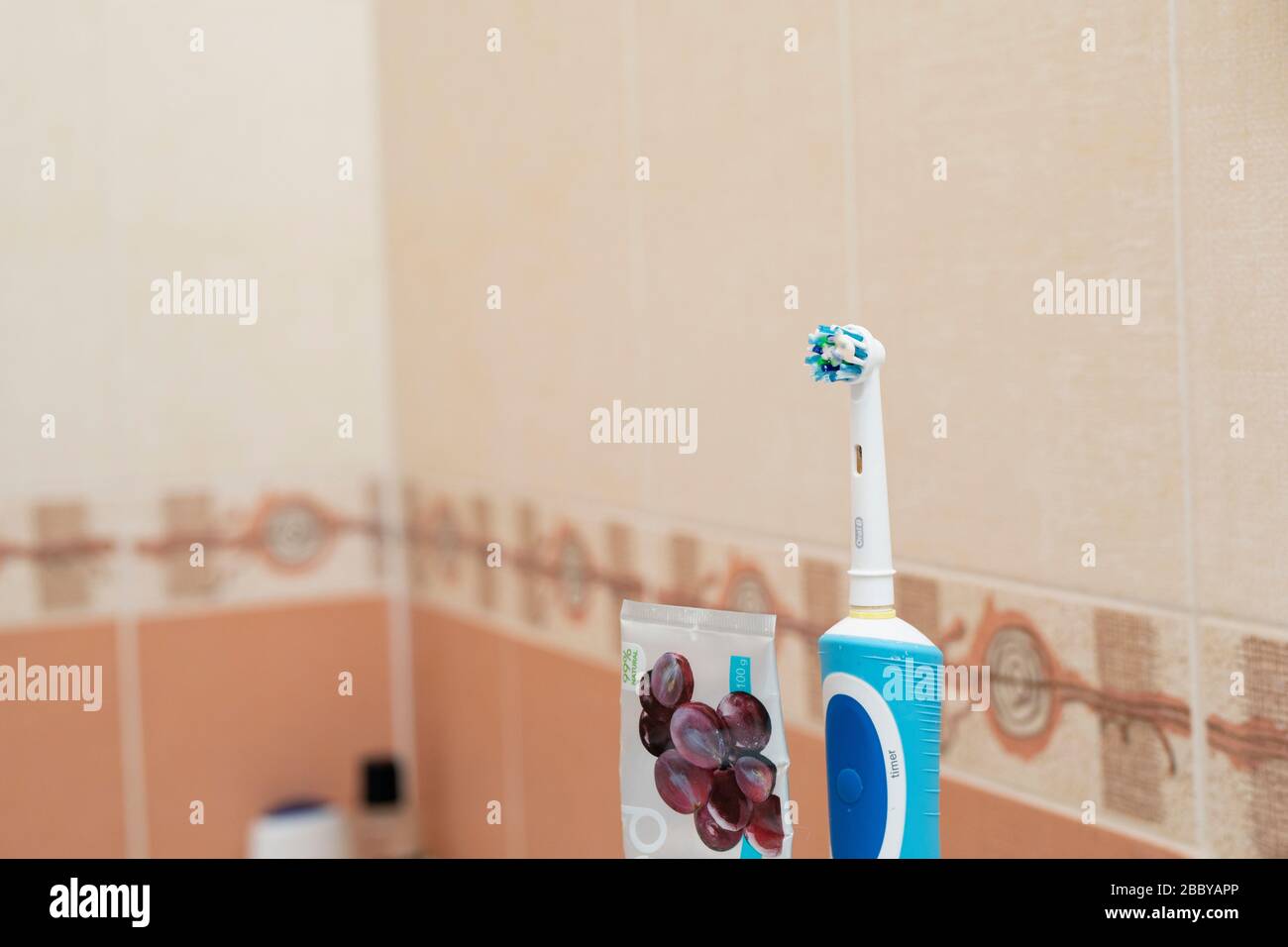 electric toothbrushe and toothpaste on blurred background at bathroom ...