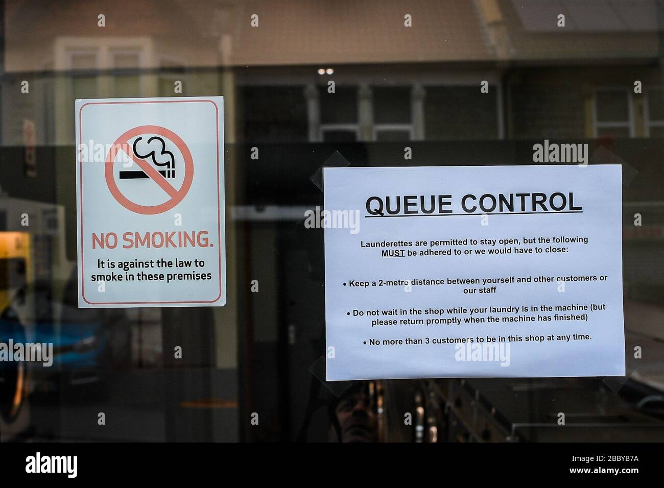A coronavirus notice in a shop doorway in Bristol as the UK continues in lockdown to help curb the spread of the coronavirus. Stock Photo