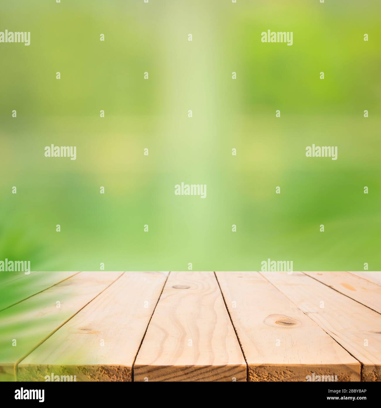 Empty wood table top on blur abstract green garden from window view.For montage product display or design key visual layout Stock Photo