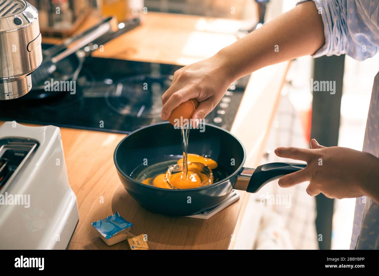 Cooking breakfast on kitchen counter bar in morning.Healthy food,simple eating lifestyle. Stock Photo