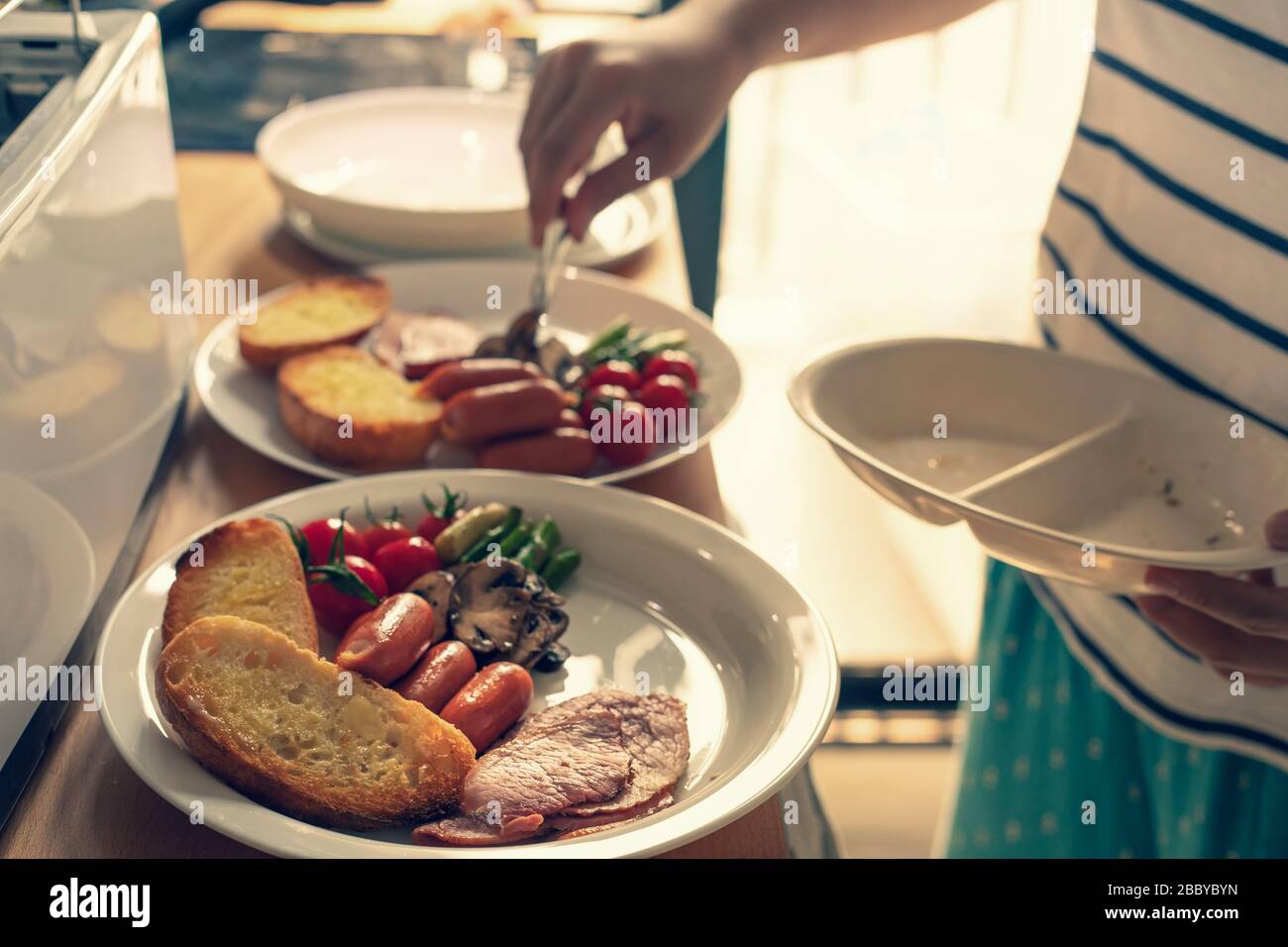 Selective focus of female cooking breakfast on kitchen counter bar.Healthy food,simple eating lifestyle. Stock Photo