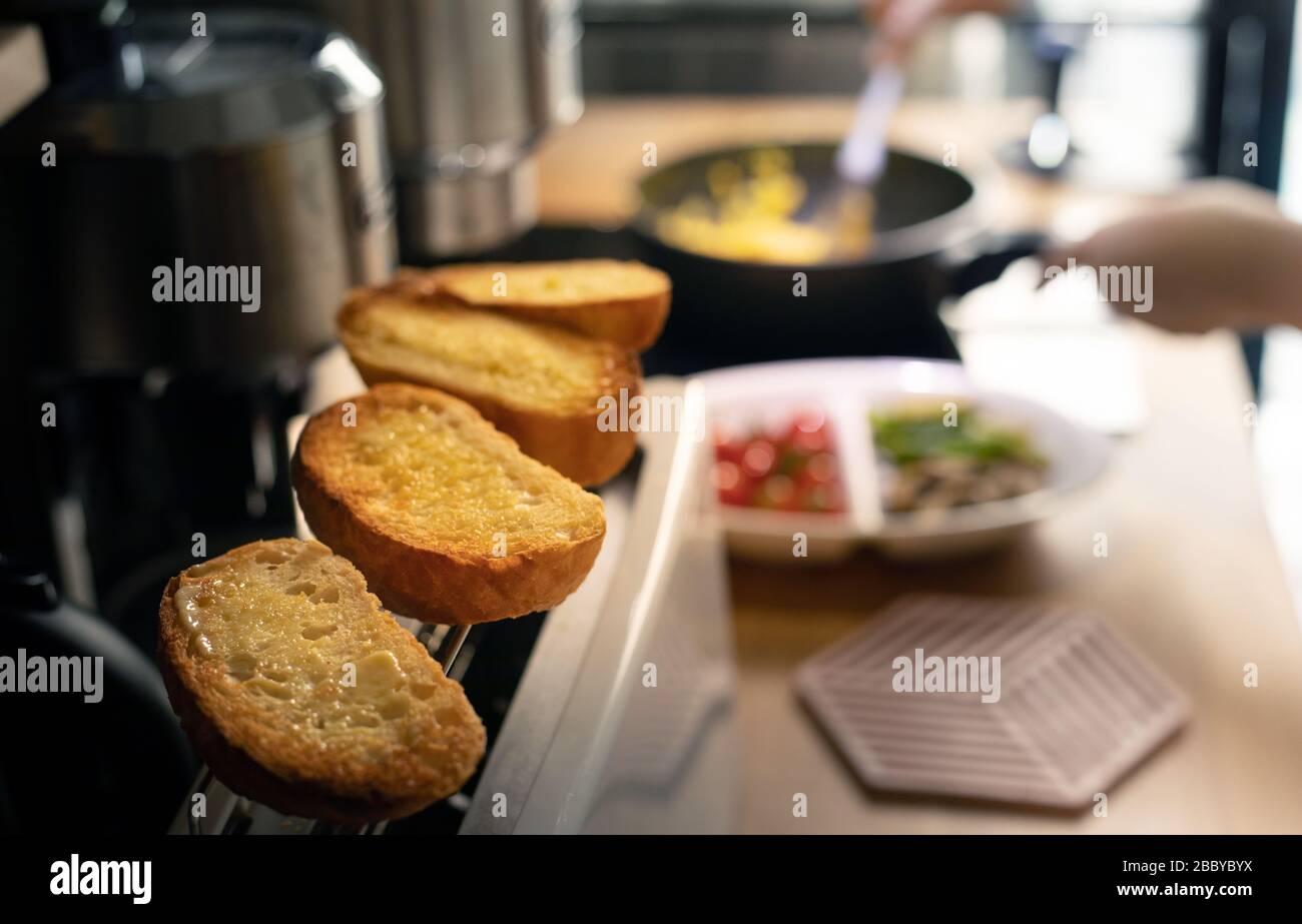 Selective focus of female cooking breakfast on kitchen counter bar.Healthy food,simple eating lifestyle. Stock Photo