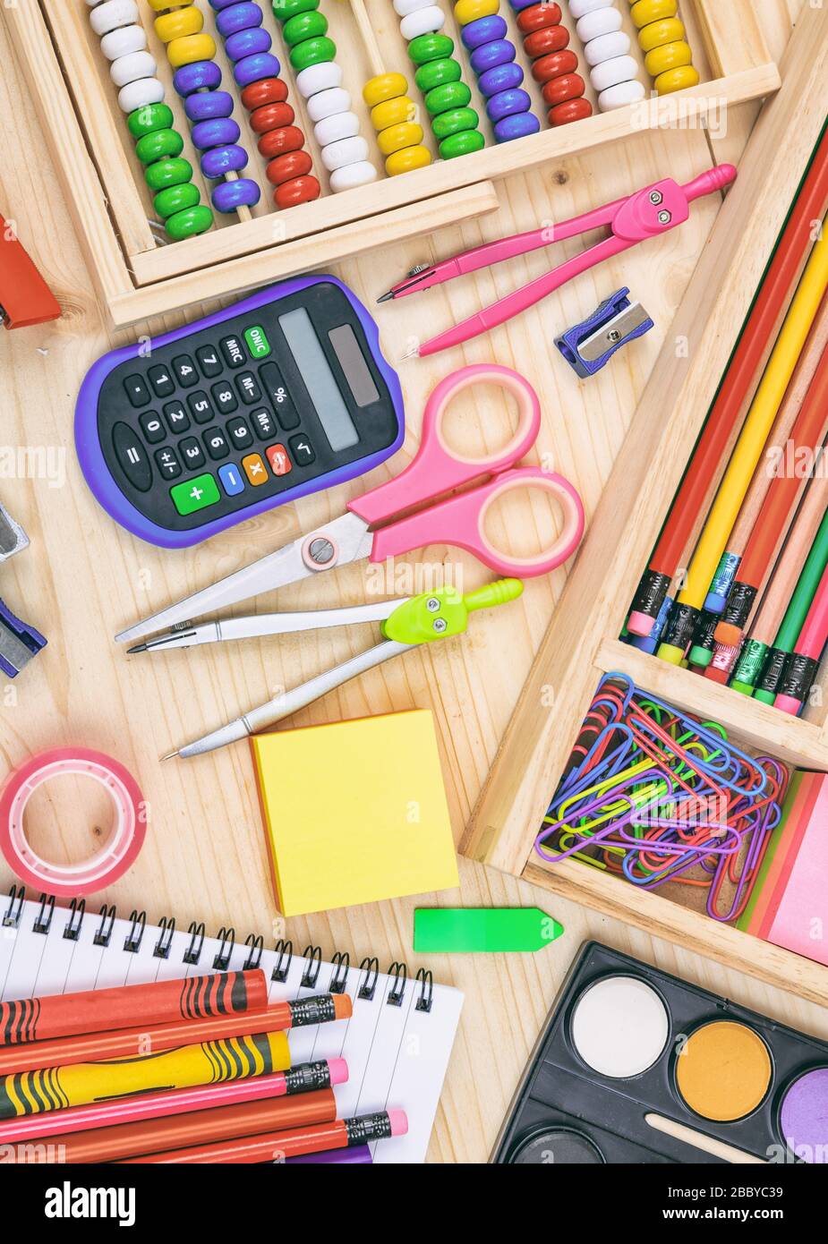 School supplies flat lay on wood background, top view. Back to school ...