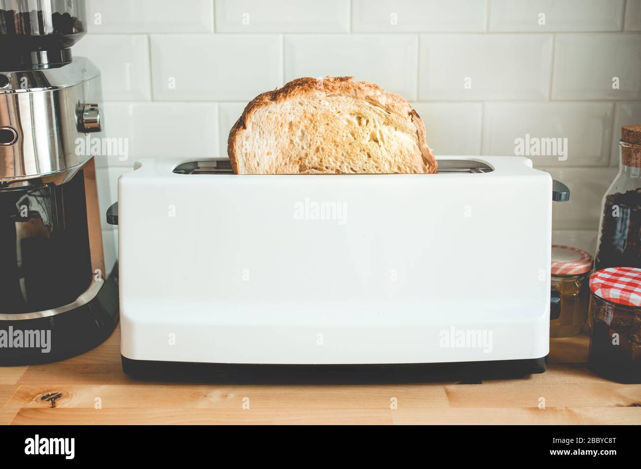 Closeup cooking bread with toaster on counter bar kitchen in morning.Simple life,healthy eating,start a day concepts ideas Stock Photo
