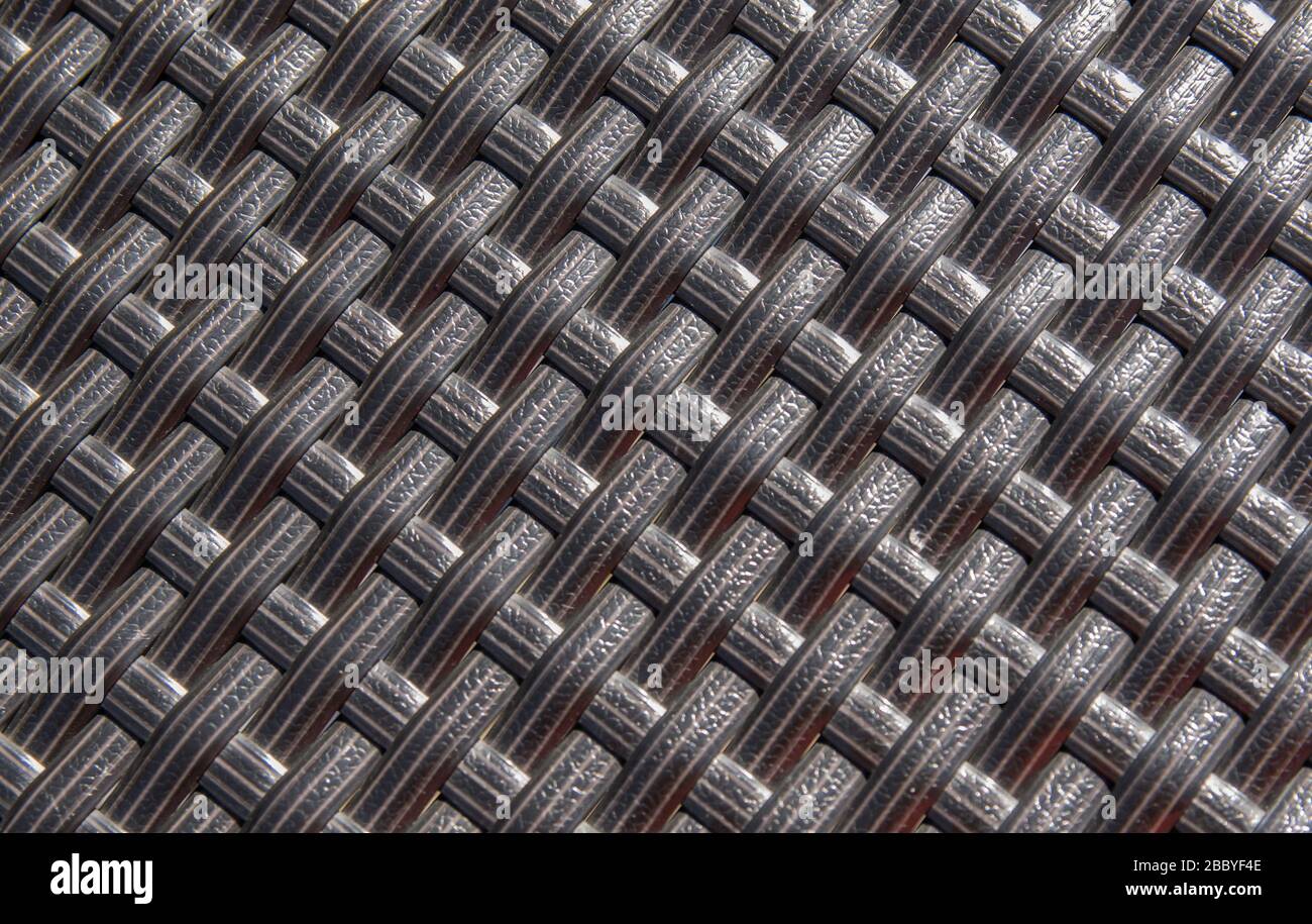 Pattern wattled surface with  plastic brown path. Texture background in sunny summer day. Stock Photo