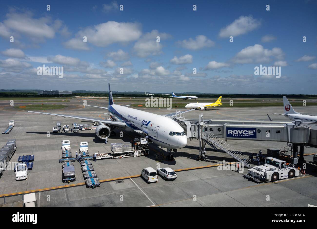 All Nippon Airways Boeing 777 waiting at a gate at New Chitose Airport in Hokkaido Japan, on a sunny day in June. Stock Photo