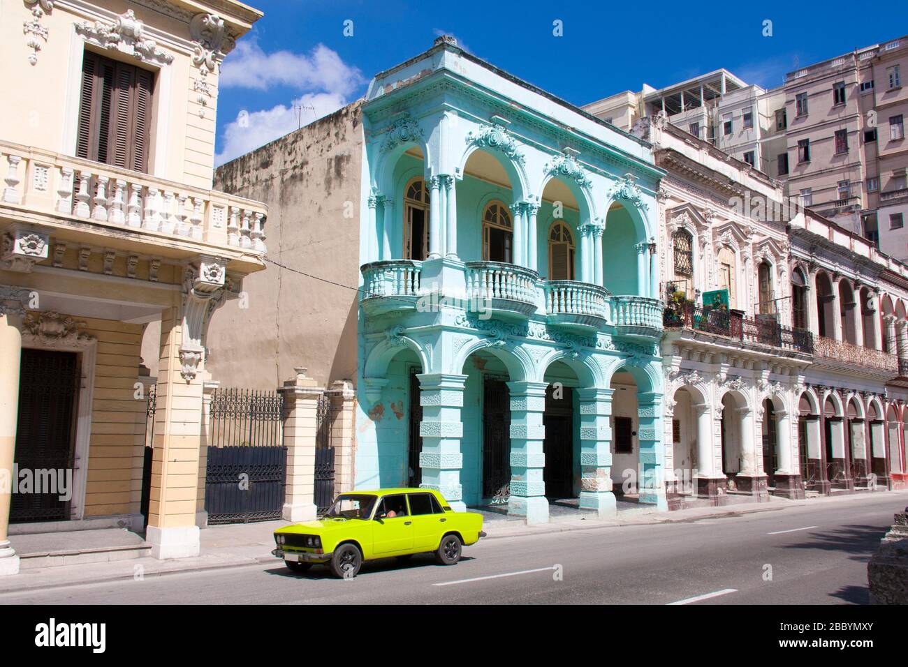 HAVANA, CUBA - APRIL 05, 2017: Phosphoric colored European car driving on the Paseo del Prado or Paseo de Martí in Havana, Cuba. Stock Photo