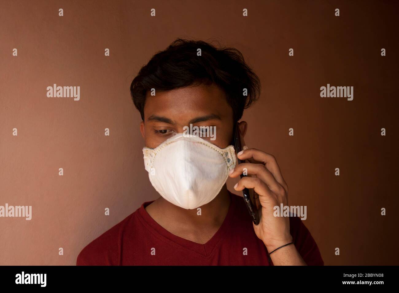 A Boy wearing a respiratory mask Talking a mobile phone Stock Photo - Alamy
