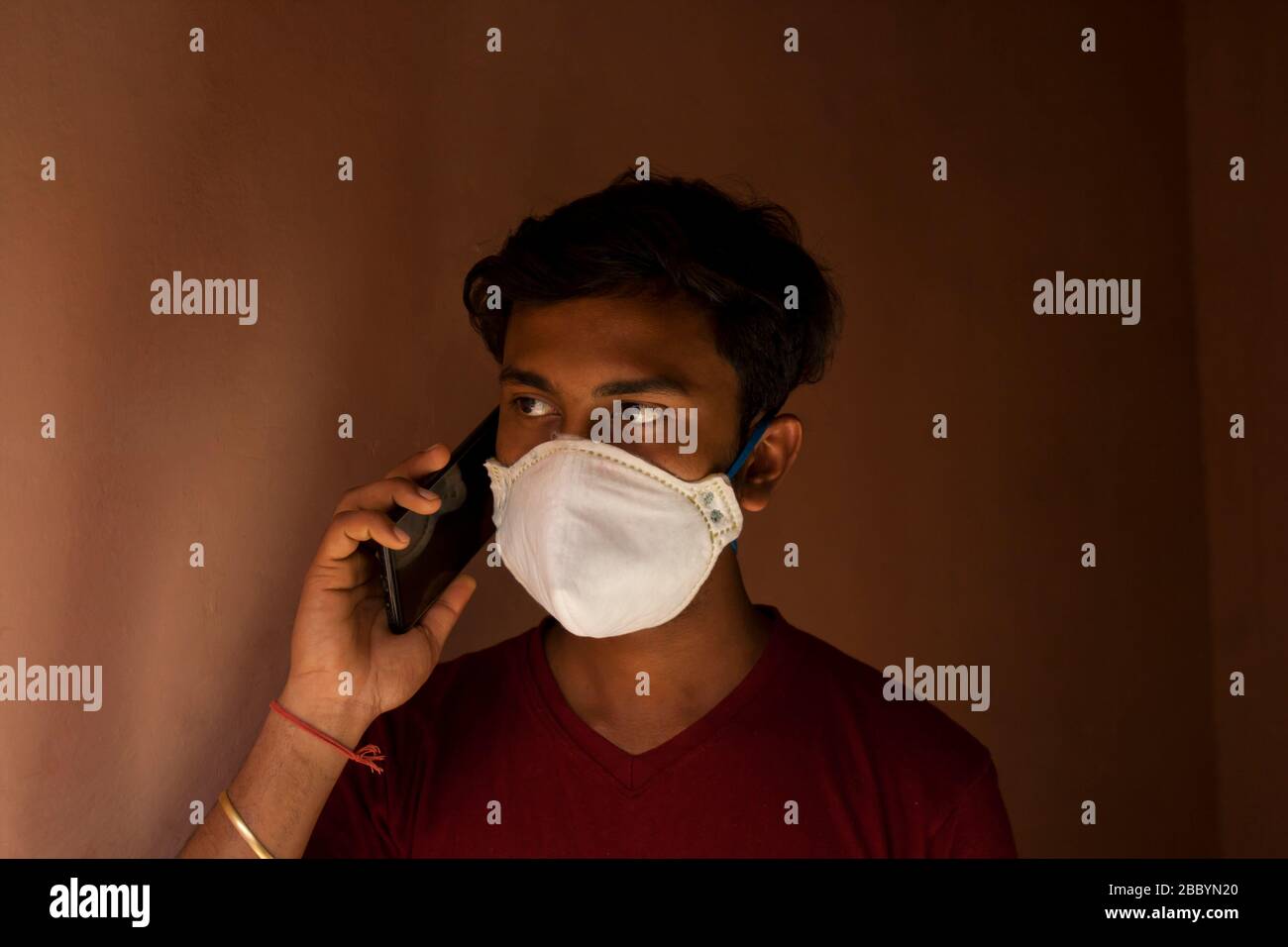 A Boy wearing a respiratory mask Talking a mobile phone Stock Photo - Alamy