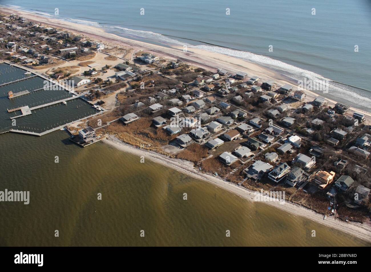 Fire Island ranged in damage from Hurricane Sandy. At the time when this photo was taken, this area appeared quiet with a bit of construction equipment handling the hardest hit sand streets. Stock Photo