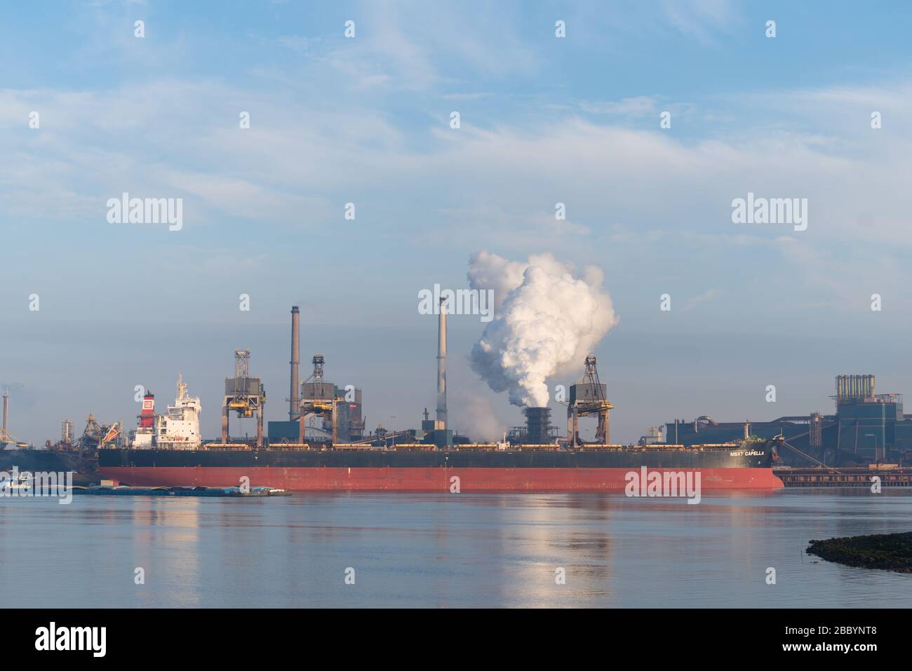 IJMUIDEN, NETHERLANDS - OCTOBER 6, 2018: Large cargo ship moored in front of Tata Steel Company Stock Photo