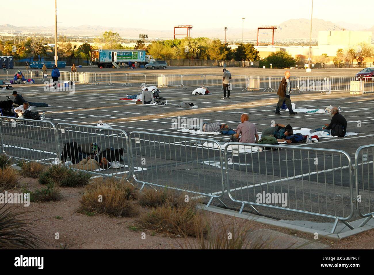 Las Vegas, United States. 1st Apr, 2020. Homeless individuals practice self-distancing measures at the Cashman Center parking lot during the Coronavirus closure in Las Vegas, Nevada on Wednesday, April 1, 2020. Photo by James Atoa/UPI Credit: UPI/Alamy Live News Stock Photo