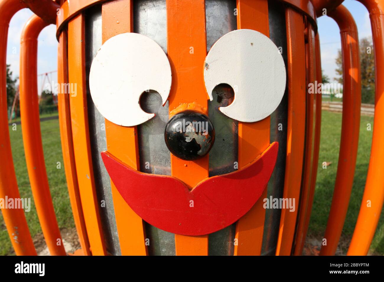 Orange litter bin with funny face. Clayhall Park, Longwood Gardens