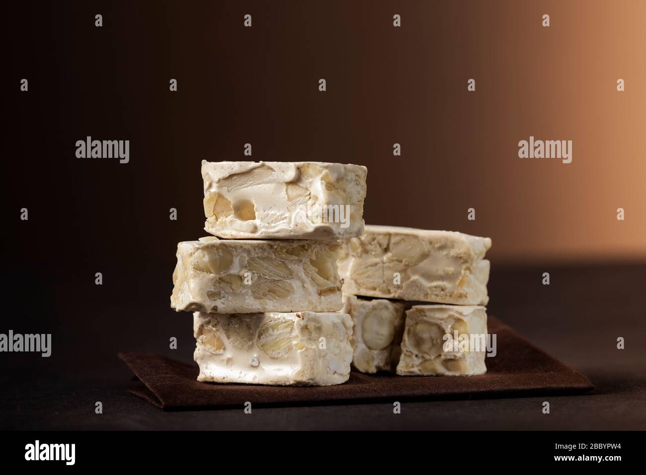 small nougat pieces on dark table Stock Photo