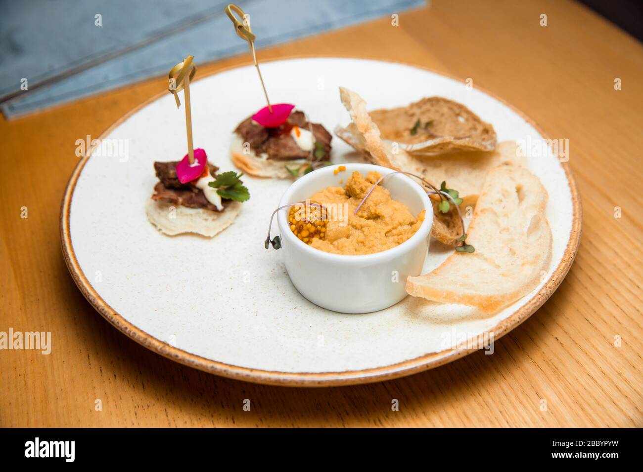 Fresh pate served with slices of crisp bread. Stock Photo