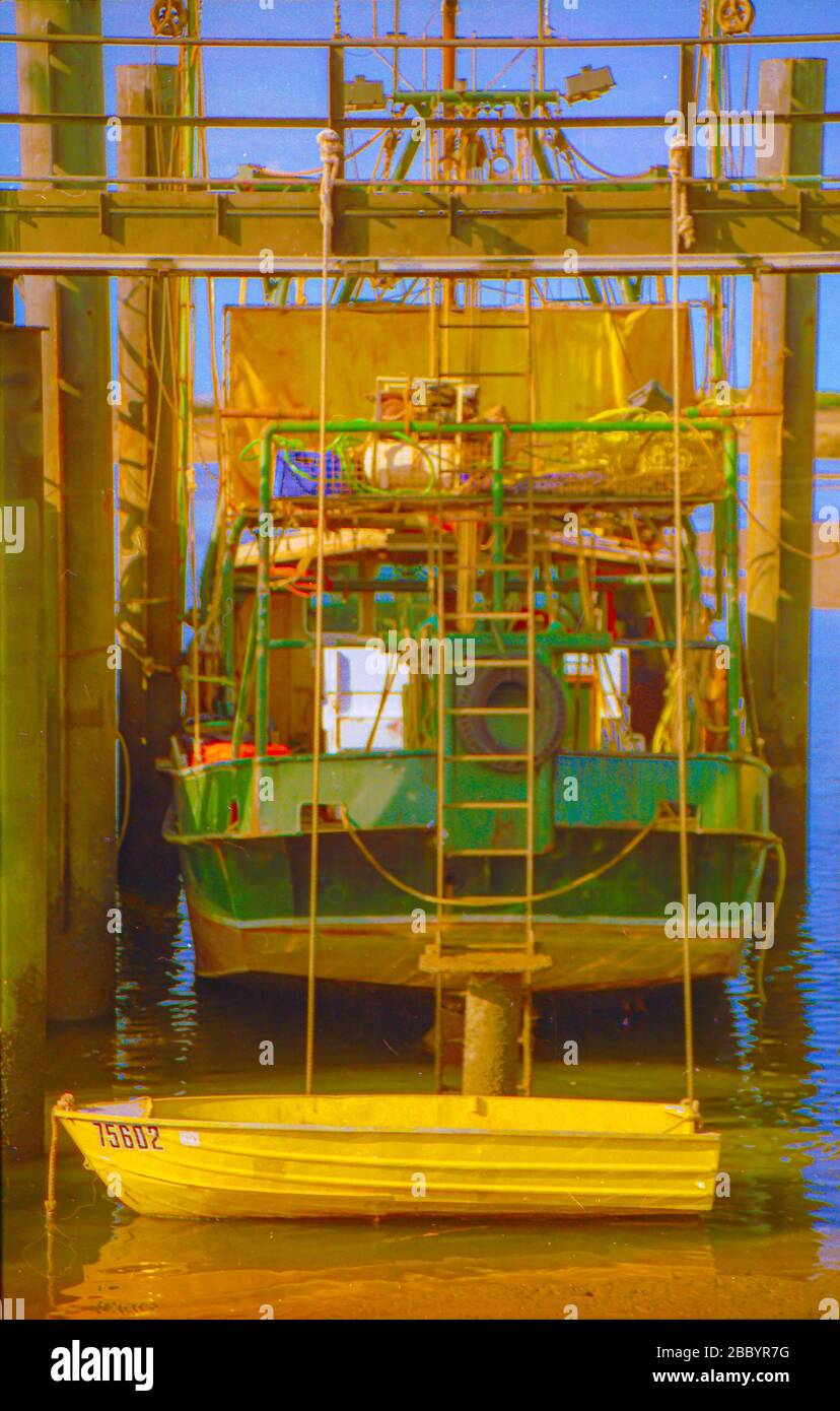 Yellow dinghy A green fishing boat and yellow dinghy at Point Samson