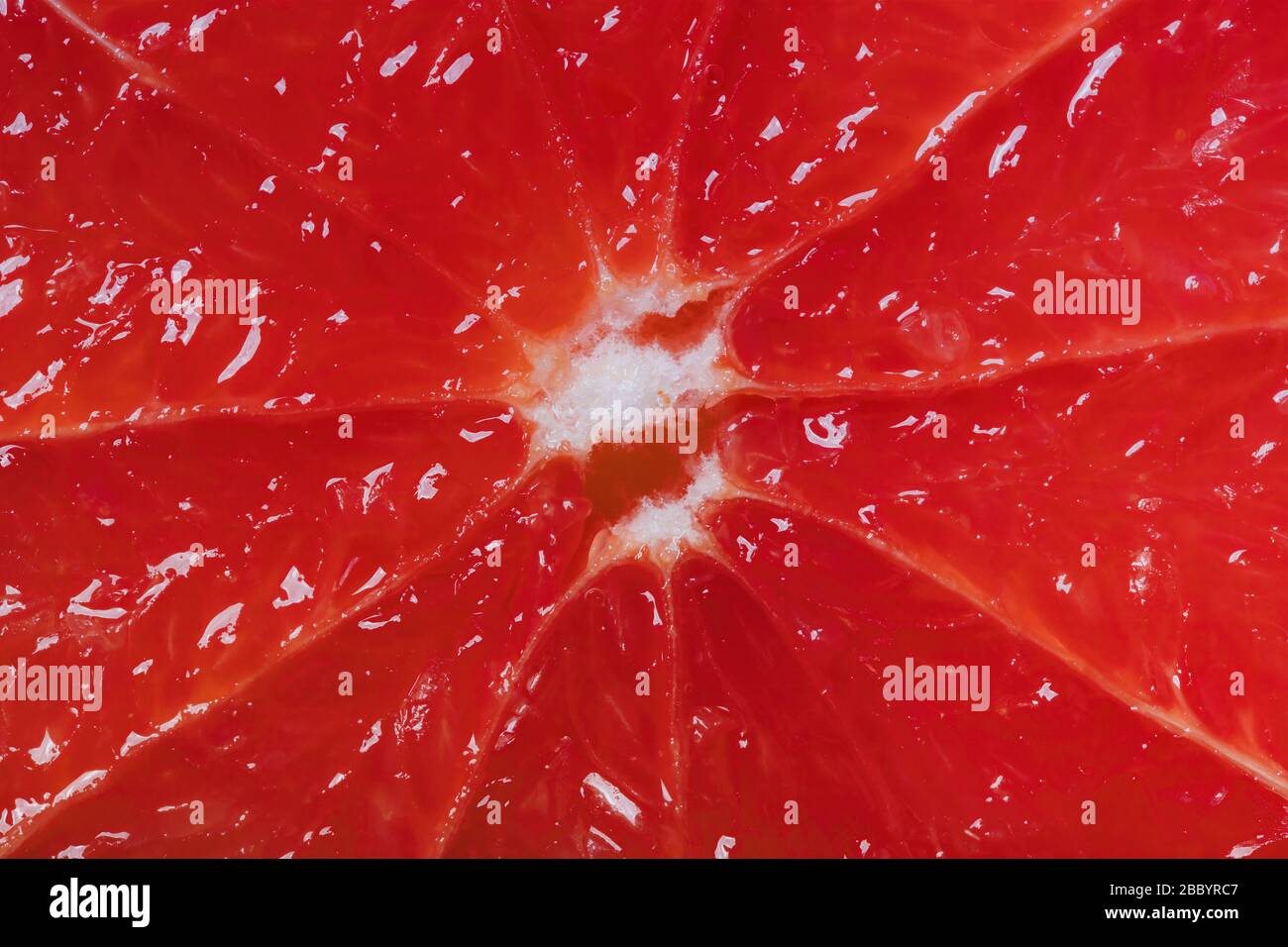 Cutted grapefruit background. Red juicy surface. Close up shot. Stock Photo