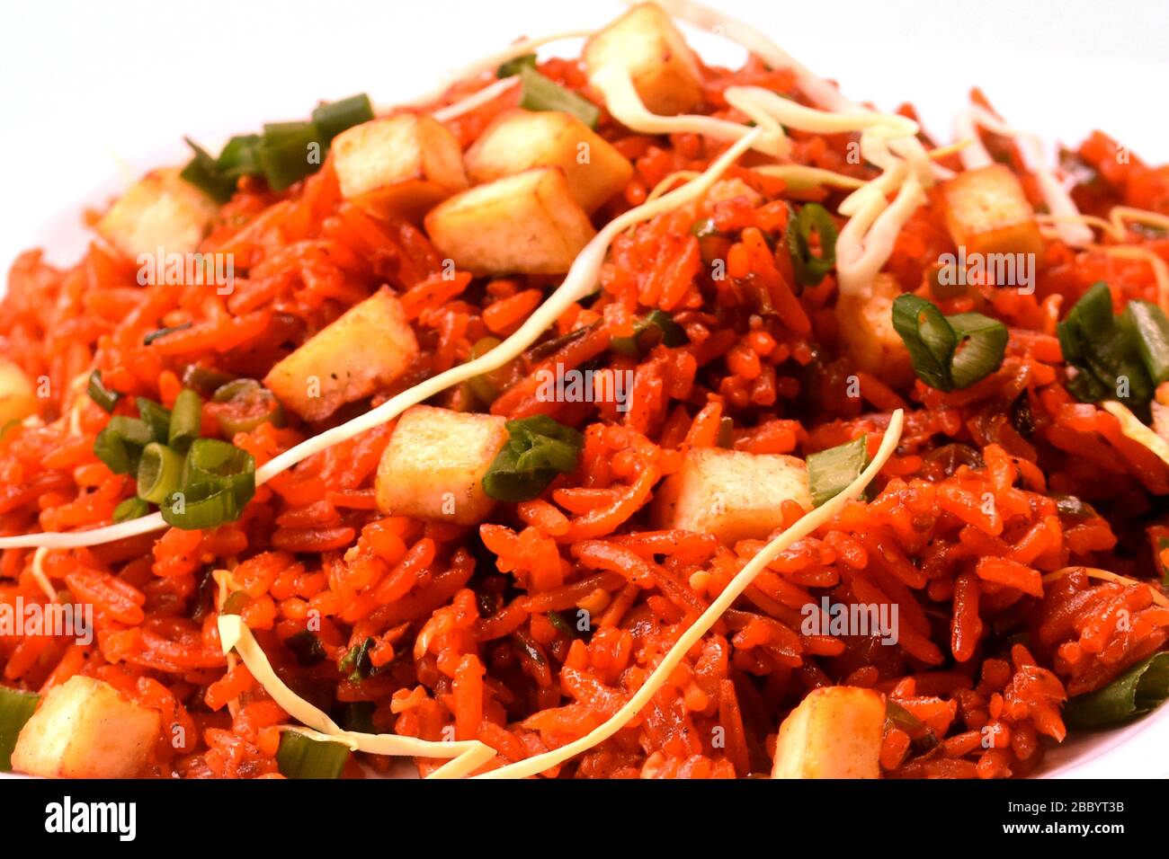 .Schezwan paneer fried rice with schezwan sauce,Chinese fried rice with paneer,garnished with spring onion and cabbage Stock Photo