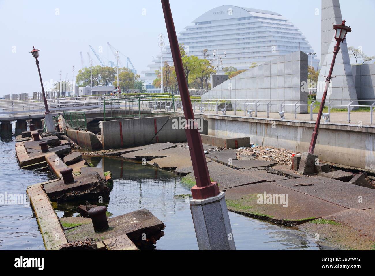 KOBE, JAPAN - APRIL 24, 2012: People visit the ruined Meriken Wharf in Kobe. It was damaged by the Great Hanshin Earthquake in 1995 and is preserved a Stock Photo