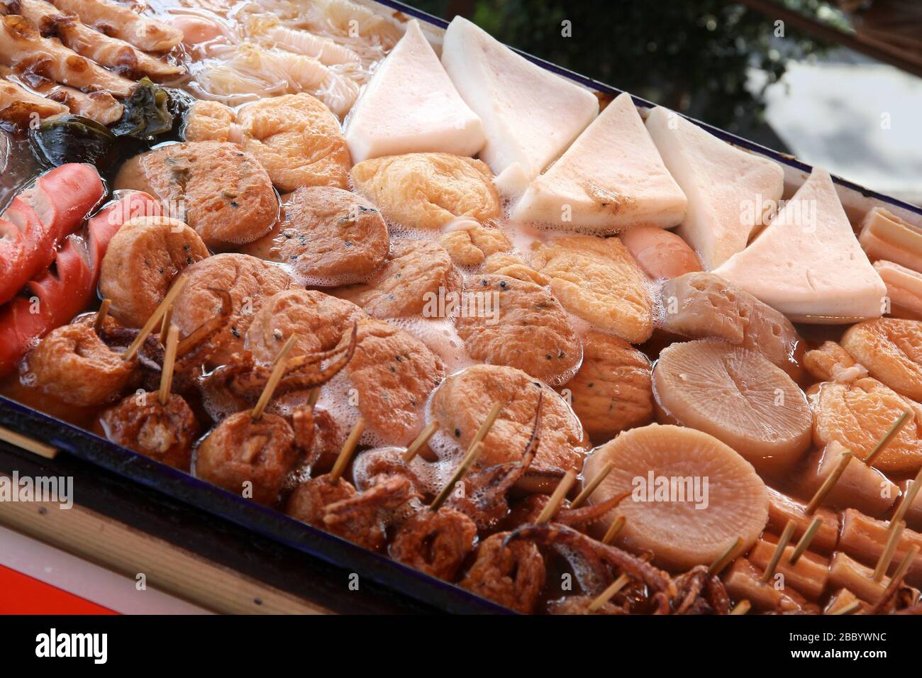 Tokyo street food. Japanese cuisine - oden food in soy broth. Typical  winter food in Japan with sausages, dumplings, tofu and daikon. Stock Photo