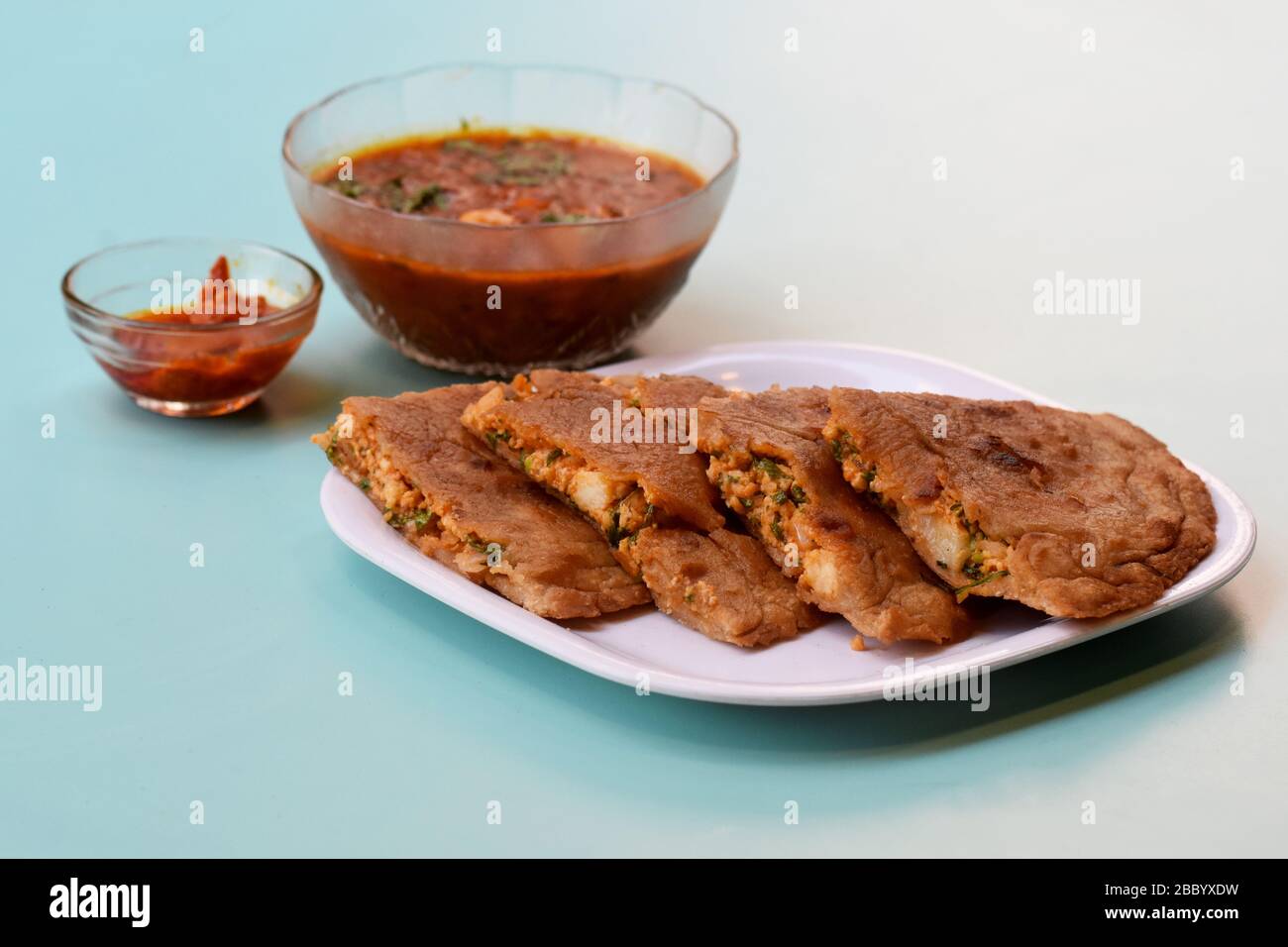 Indian flatbread - Aloo Kulcha with Choley or Stuffed Potato Bread or Stuffed Aloo paratha with tomato ketchup, white chickpeas & pickle - Image. Stock Photo