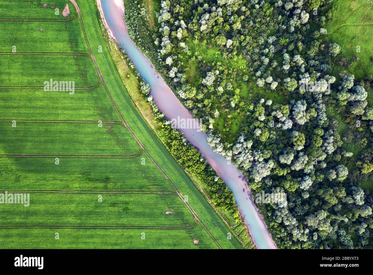 Flight through majestic Ukrainian landscape with river Dnister and green fields at sunset time. Summertime Stock Photo