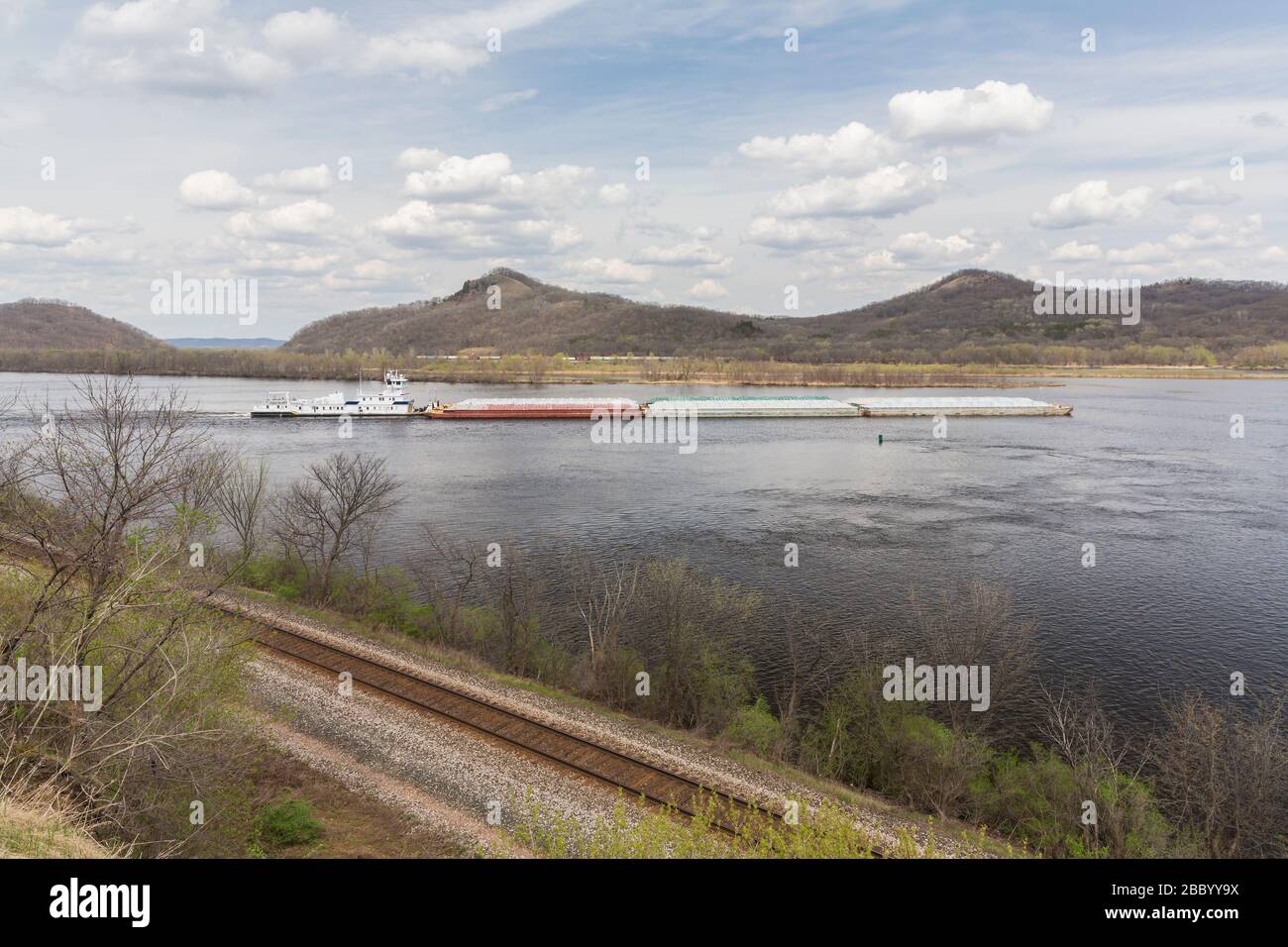 A barge on the Mississippi River during spring. Stock Photo