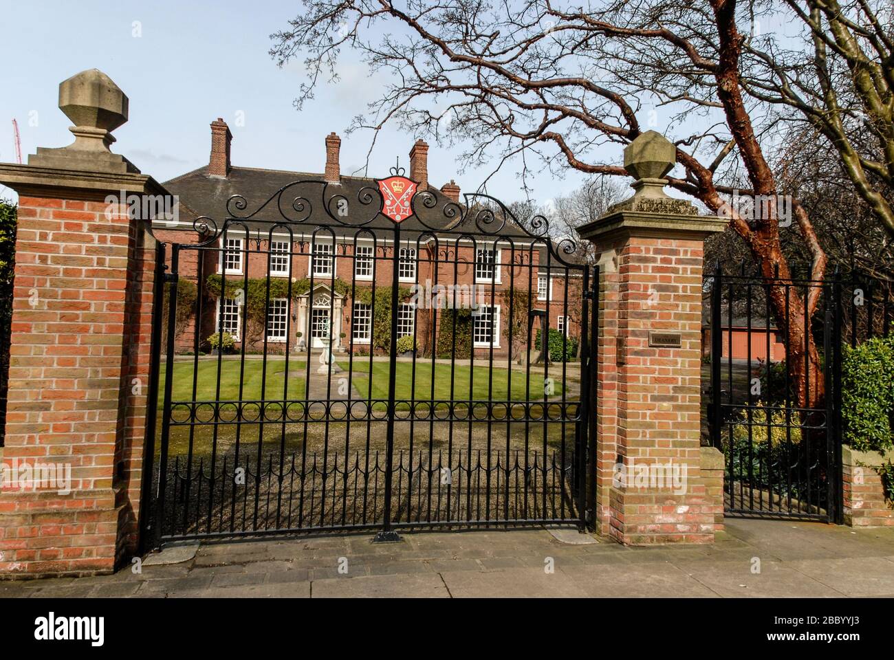 The Deanery in Dean's Park is close to York Minster, York, England.  At the top of the main gate is the Archbishop of York arms. Stock Photo