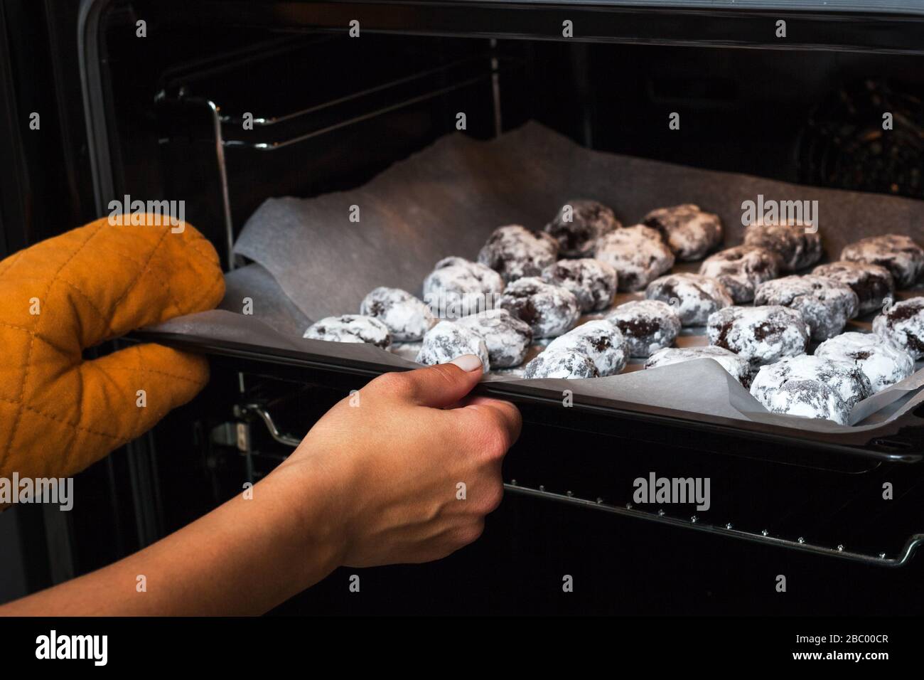 The process of baking brownie cookies. The photo shows female hands
