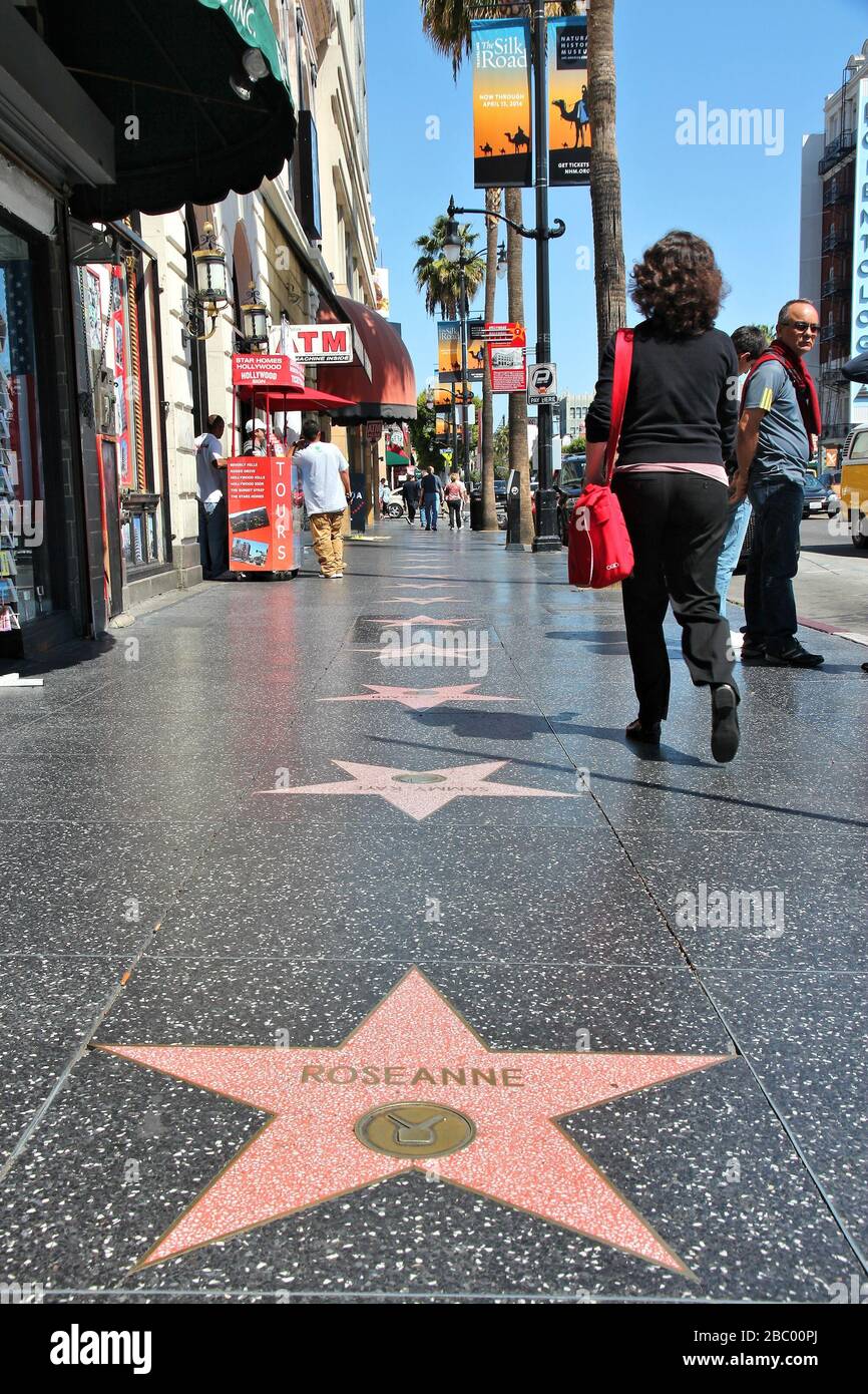 LOS ANGELES, USA - APRIL 5, 2014: People visit Walk of Fame in Hollywood. Hollywood Walk of Fame features more than 2,500 stars with inscribed celebri Stock Photo