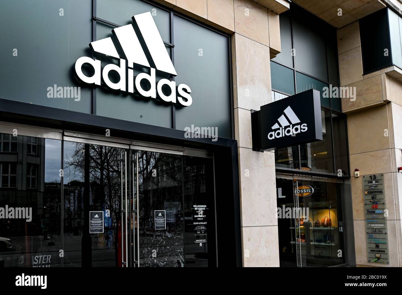 Hamburg, Germany. 01st Apr, 2020. The logo the sporting goods manufacturer adidas hangs above the entrance of the department store in downtown Hamburg. Credit: Heimken/dpa/Alamy Live News Stock Photo -
