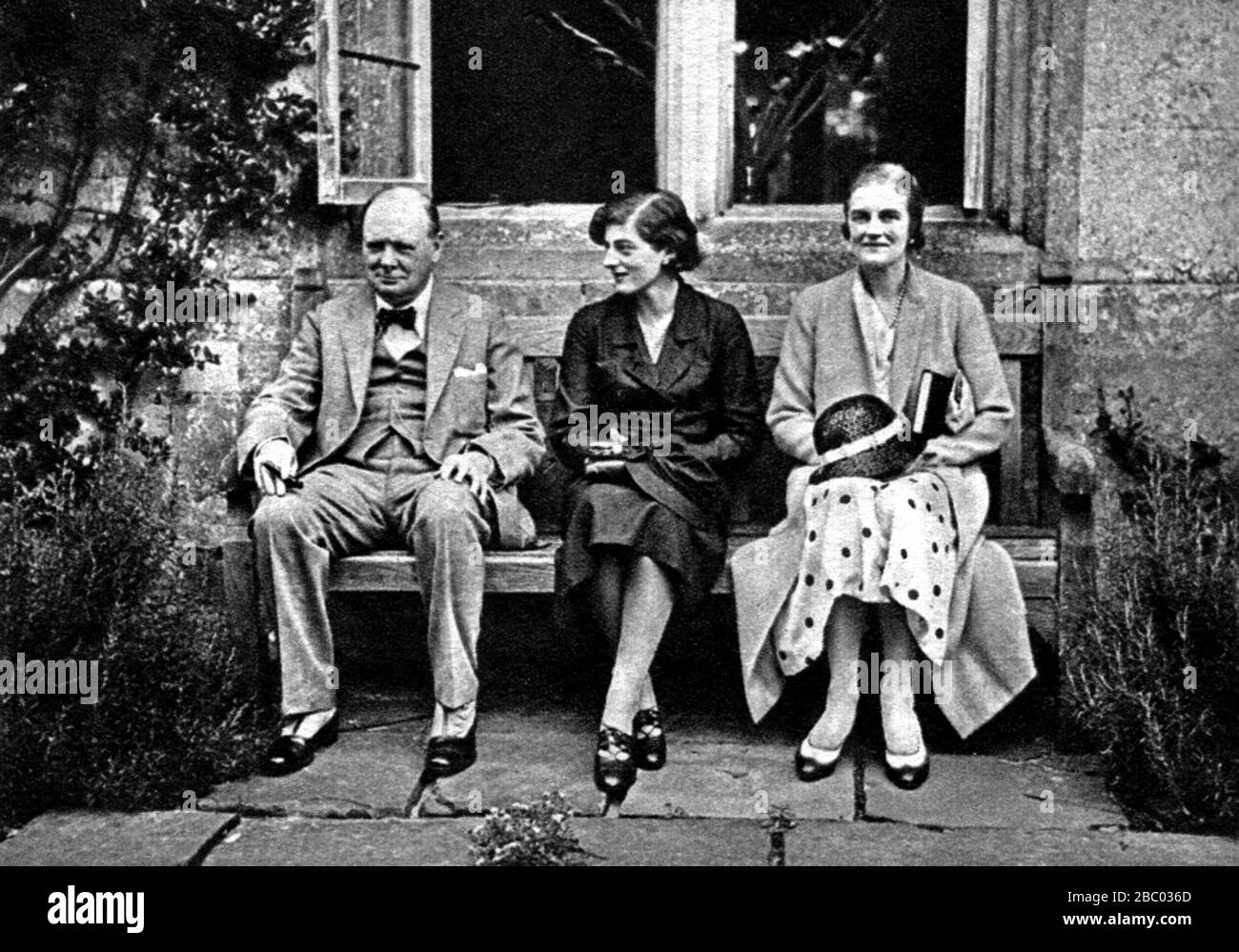 Winston Churchill with his wife and daughter Sarah at Cranborne Manor, Dorset.  Home of the Marquis of Salisbury. August 1932. Stock Photo