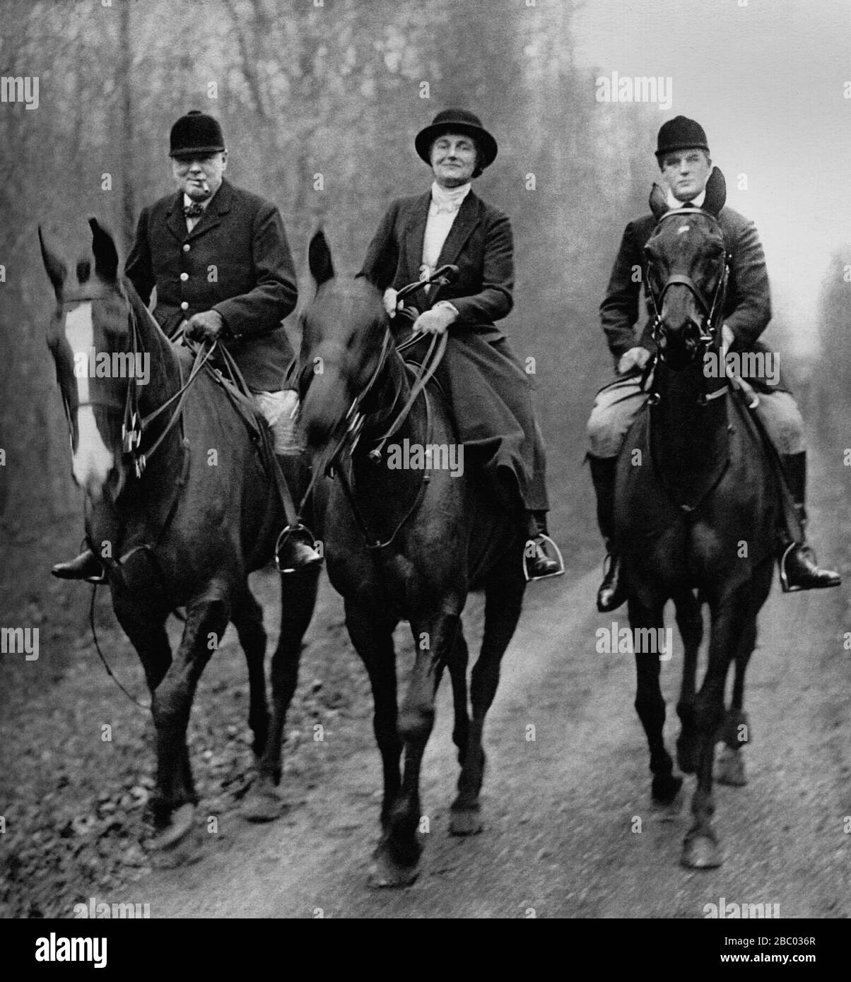 Winston Churchill hunting on horseback with The Duke of Westminster's boar hounds in Normandy.  With him: Mrs Churchill and son Randolph.20th Jan.1933 Stock Photo