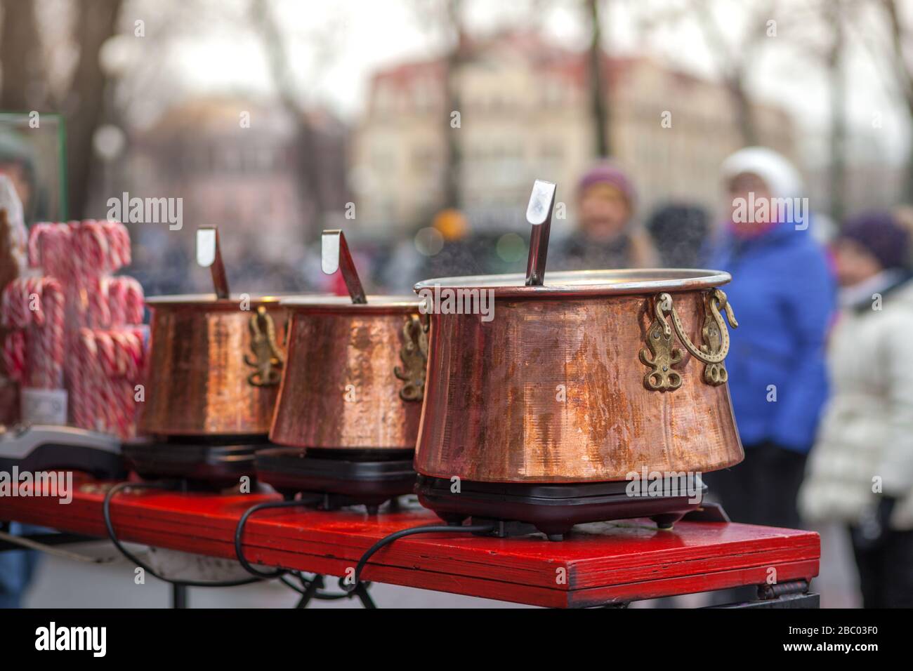 Street food. Hot mulled wine. Steam over hot wine pots. Outside. Close