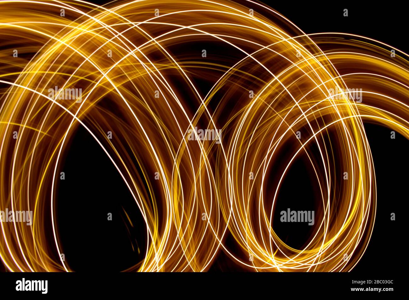 Long exposure photo of neon gold colour in an abstract swirl, parallel ...