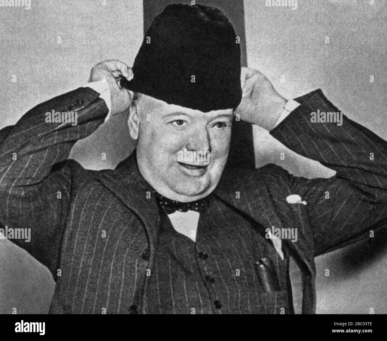 Winston Churchill trying on a sealskin hat presented to him in Ottawa at his address to the Canadian House of Commons.  31st December 1941. Stock Photo